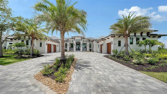15315 Anchorage Pl, Lakewood Ranch, FL 34202 - view of front of property featuring a garage, decorative driveway, and stucco siding