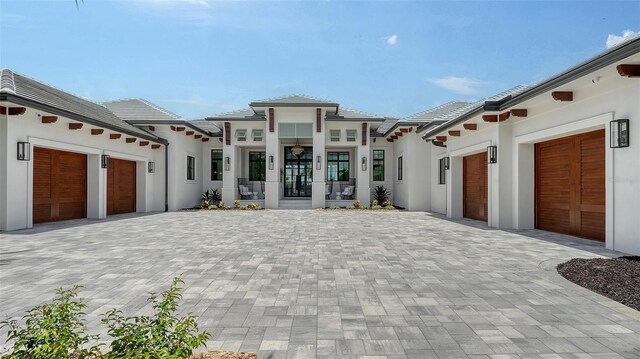 15315 Anchorage Pl, Lakewood Ranch, FL 34202 - view of front facade with a garage, decorative driveway, stucco siding, and a tile roof