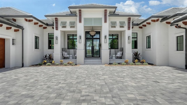 15315 Anchorage Pl, Lakewood Ranch, FL 34202 - view of front of home with a tiled roof, stucco siding, and covered porch