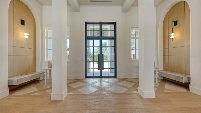 15315 Anchorage Pl, Lakewood Ranch, FL 34202 - entryway with arched walkways, beam ceiling, light wood-style flooring, and french doors
