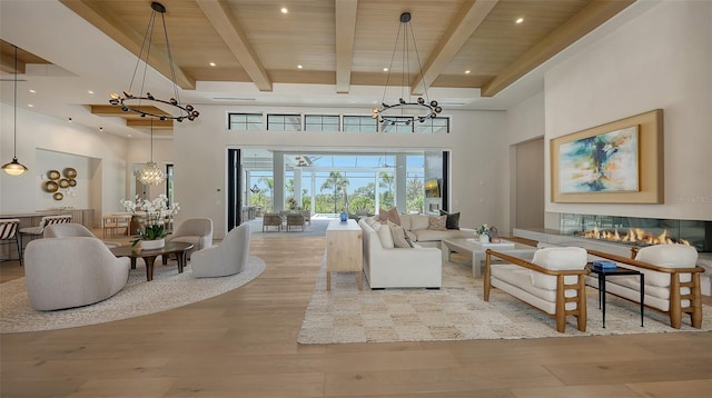 15315 Anchorage Pl, Lakewood Ranch, FL 34202 - living room with a chandelier, wood finished floors, a towering ceiling, a wooden ceiling with exposed beams, and recessed lighting