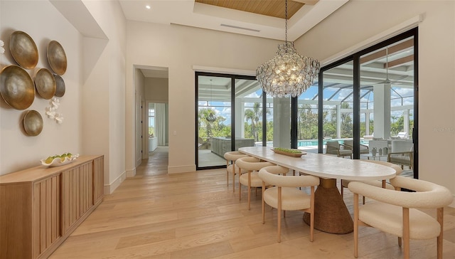 15315 Anchorage Pl, Lakewood Ranch, FL 34202 - dining space featuring healthy amount of natural light, light wood-type flooring, a towering ceiling, a chandelier, and a ceiling fan
