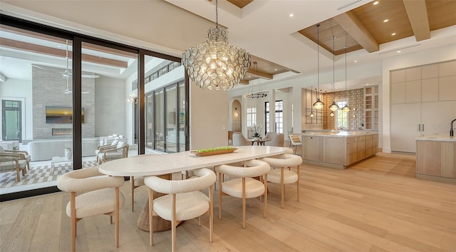 15315 Anchorage Pl, Lakewood Ranch, FL 34202 - dining space featuring light wood finished floors, a chandelier, beam ceiling, recessed lighting, and arched walkways