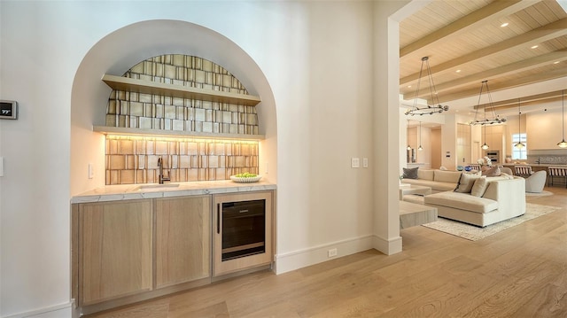 15315 Anchorage Pl, Lakewood Ranch, FL 34202 - indoor wet bar featuring wine cooler, a wooden ceiling with exposed beams, light wood finished floors, hanging light fixtures, and recessed lighting