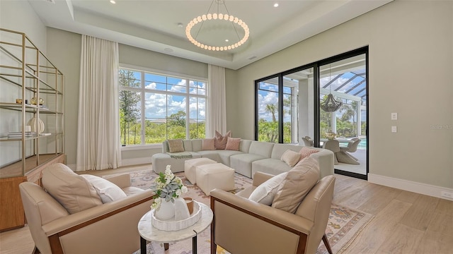 15315 Anchorage Pl, Lakewood Ranch, FL 34202 - living room with light wood finished floors, a raised ceiling, and recessed lighting