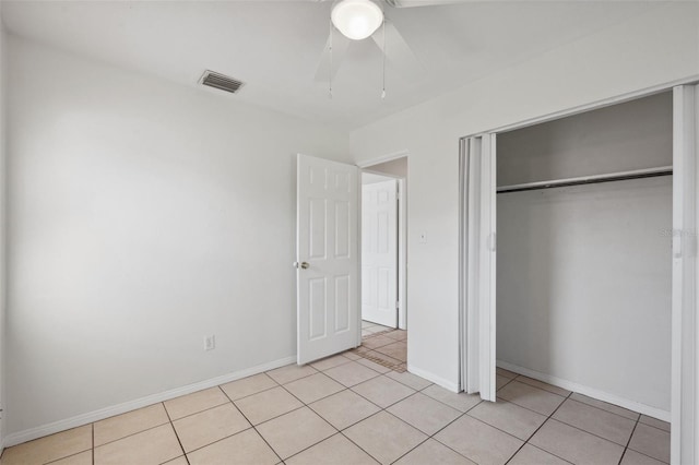 1404 Dartmouth Dr, Bradenton, FL 34207 - unfurnished bedroom featuring light tile patterned floors, a closet, and a ceiling fan