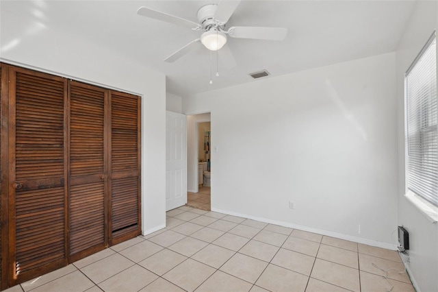 1404 Dartmouth Dr, Bradenton, FL 34207 - unfurnished bedroom with a closet, light tile patterned floors, multiple windows, and a ceiling fan