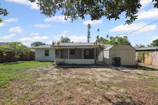 1404 Dartmouth Dr, Bradenton, FL 34207 - rear view of house featuring a sunroom, a fenced backyard, and a storage shed