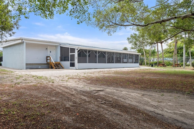 1404 Dartmouth Dr, Bradenton, FL 34207 - back of house with a sunroom and entry steps