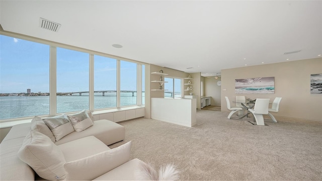 350 Golden Gate Pt Unit 61, Sarasota, FL 34236 - living room with a water view and light carpet