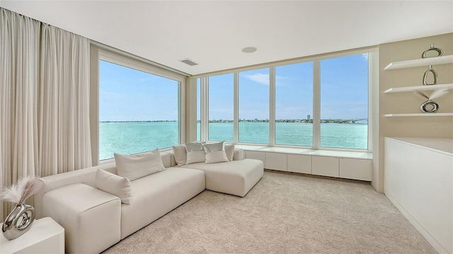 350 Golden Gate Pt Unit 61, Sarasota, FL 34236 - carpeted living room with a water view