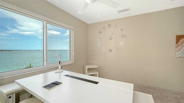 350 Golden Gate Pt Unit 61, Sarasota, FL 34236 - home office featuring a water view, ceiling fan, and carpet flooring