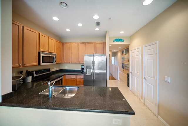 4235 Overture Cir Unit 4235, Bradenton, FL 34209 - kitchen featuring stainless steel appliances, a peninsula, light tile patterned floors, recessed lighting, and light brown cabinets