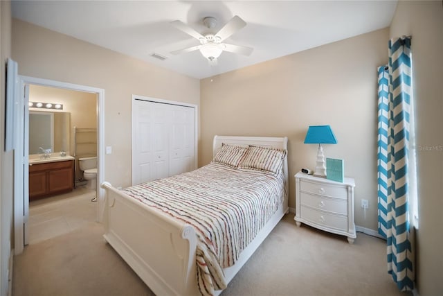 4235 Overture Cir Unit 4235, Bradenton, FL 34209 - bedroom with light carpet, a closet, connected bathroom, and a ceiling fan