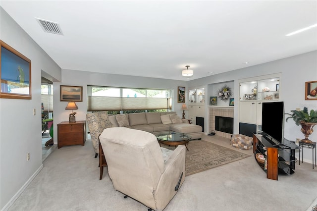 5417 Champagne Unit 63, Sarasota, FL 34235 - living room featuring light colored carpet and a fireplace with flush hearth
