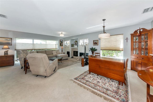 5417 Champagne Unit 63, Sarasota, FL 34235 - carpeted living area featuring healthy amount of natural light and a fireplace