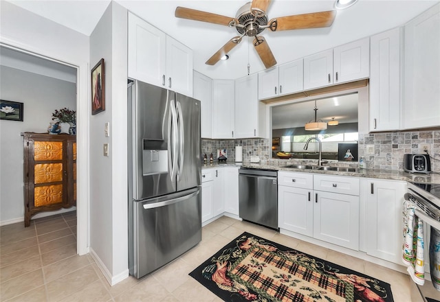 5417 Champagne Unit 63, Sarasota, FL 34235 - kitchen with stainless steel appliances, tasteful backsplash, a ceiling fan, and white cabinetry