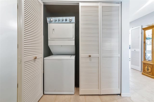 5417 Champagne Unit 63, Sarasota, FL 34235 - laundry area featuring stacked washer and clothes dryer and light tile patterned floors