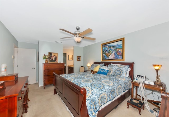5417 Champagne Unit 63, Sarasota, FL 34235 - bedroom featuring light colored carpet, connected bathroom, and a ceiling fan