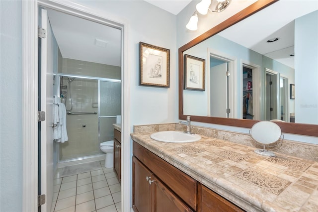 5417 Champagne Unit 63, Sarasota, FL 34235 - bathroom with tile patterned flooring, double vanity, a stall shower, and a walk in closet