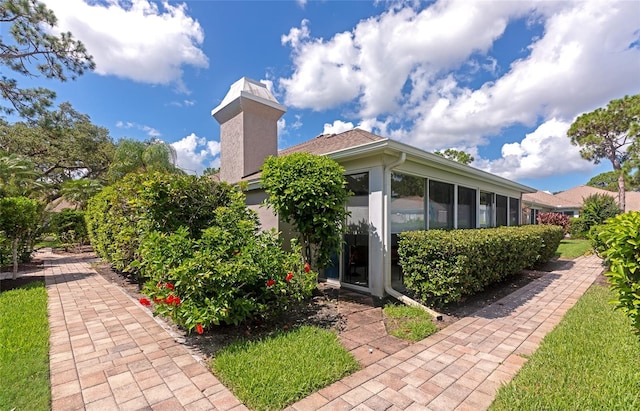5417 Champagne Unit 63, Sarasota, FL 34235 - view of property exterior with a chimney and stucco siding