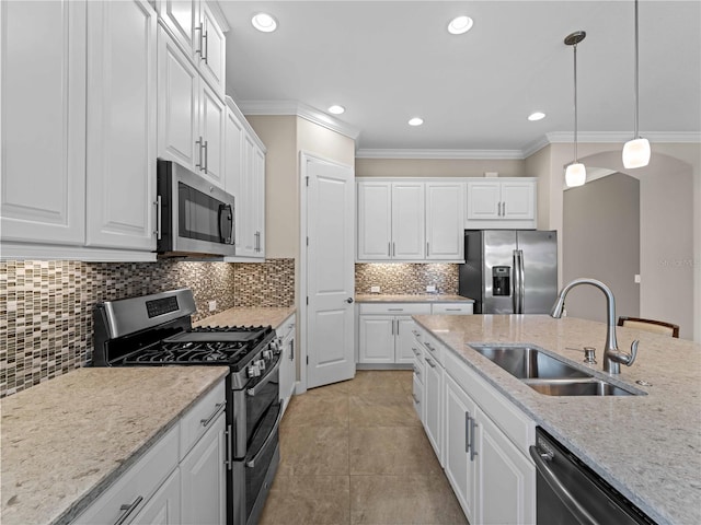 5364 Salcano St, Sarasota, FL 34238 - kitchen with stainless steel appliances, crown molding, white cabinetry, decorative light fixtures, and recessed lighting
