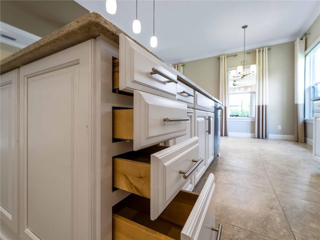 5364 Salcano St, Sarasota, FL 34238 - kitchen with a chandelier, hanging light fixtures, and white cabinetry