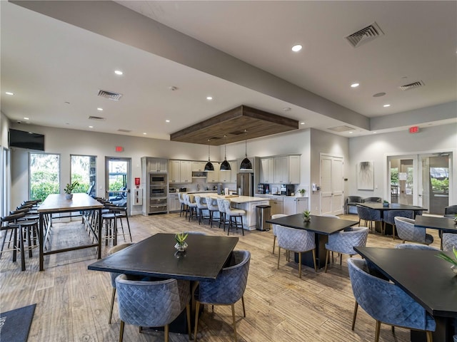 5364 Salcano St, Sarasota, FL 34238 - dining area with light wood-style floors and recessed lighting