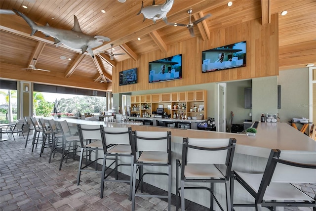 5364 Salcano St, Sarasota, FL 34238 - kitchen with a wooden ceiling with exposed beams, high vaulted ceiling, healthy amount of natural light, wooden walls, and a breakfast bar area
