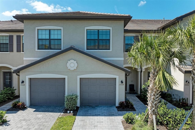 15164 Sunny Day Dr, Bradenton, FL 34211 - view of property with a garage, decorative driveway, and stucco siding