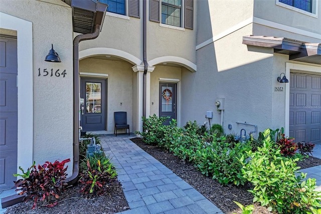 15164 Sunny Day Dr, Bradenton, FL 34211 - doorway to property featuring a garage and stucco siding