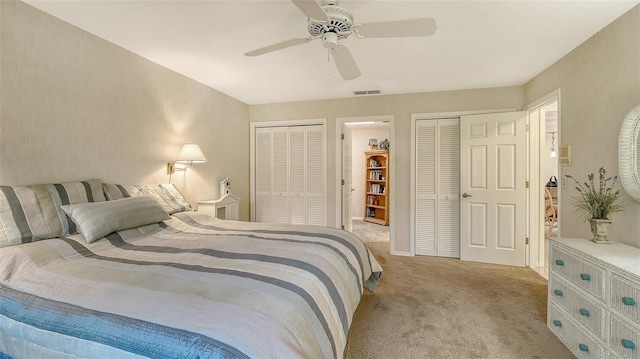 7426 Weeping Willow Blvd, Sarasota, FL 34241 - bedroom featuring multiple closets, light carpet, and ceiling fan