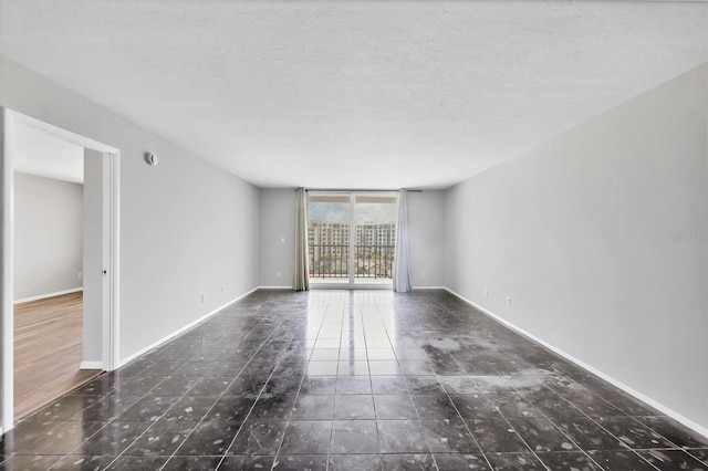 101 S Gulfstream Ave Unit 15C, Sarasota, FL 34236 - spare room with a textured ceiling and tile patterned floors