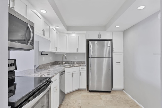 101 S Gulfstream Ave Unit 15C, Sarasota, FL 34236 - kitchen with appliances with stainless steel finishes, recessed lighting, light stone counters, and white cabinetry