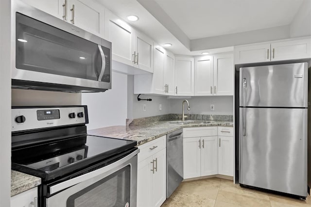 101 S Gulfstream Ave Unit 15C, Sarasota, FL 34236 - kitchen featuring stainless steel appliances, white cabinets, light stone countertops, and recessed lighting