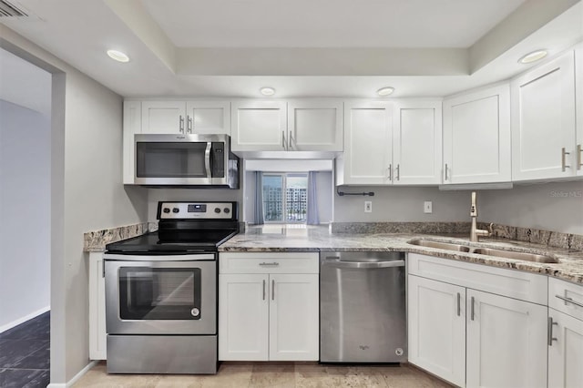 101 S Gulfstream Ave Unit 15C, Sarasota, FL 34236 - kitchen with stainless steel appliances, white cabinets, light stone countertops, and recessed lighting