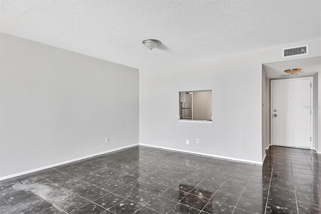 101 S Gulfstream Ave Unit 15C, Sarasota, FL 34236 - tiled spare room featuring a textured ceiling and baseboards