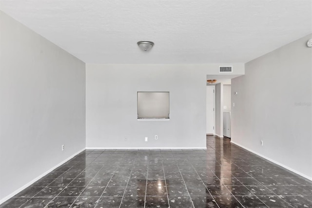 101 S Gulfstream Ave Unit 15C, Sarasota, FL 34236 - tiled spare room with baseboards and a textured ceiling