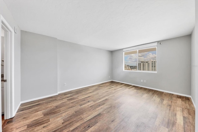 101 S Gulfstream Ave Unit 15C, Sarasota, FL 34236 - empty room with wood finished floors and baseboards