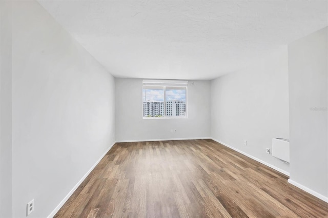 101 S Gulfstream Ave Unit 15C, Sarasota, FL 34236 - spare room with wood finished floors and baseboards
