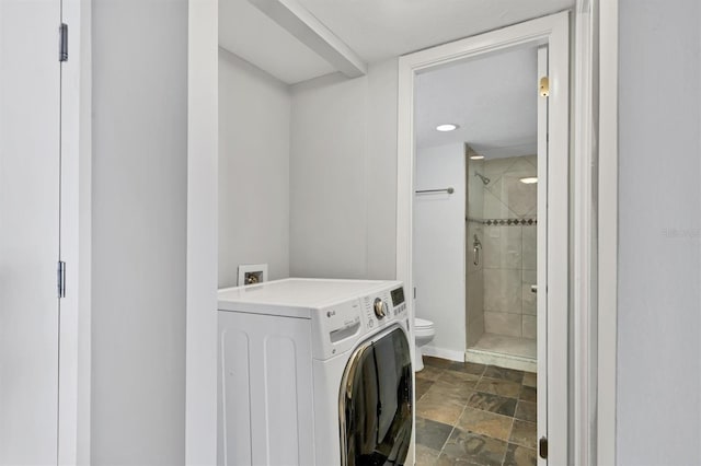 101 S Gulfstream Ave Unit 15C, Sarasota, FL 34236 - washroom featuring washer / clothes dryer and dark stone finish floors
