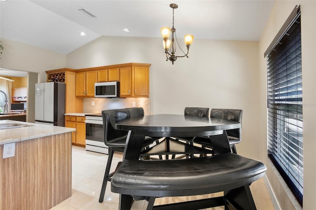 2761 Feiffer Cir, Sarasota, FL 34235 - dining space featuring light tile patterned floors and vaulted ceiling