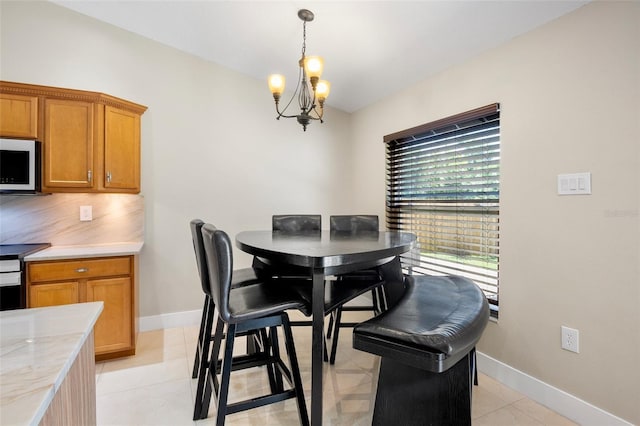 2761 Feiffer Cir, Sarasota, FL 34235 - dining area with a chandelier and baseboards