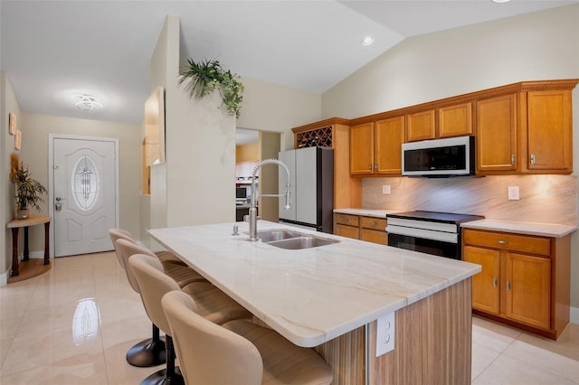 2761 Feiffer Cir, Sarasota, FL 34235 - kitchen featuring white appliances, light tile patterned floors, tasteful backsplash, lofted ceiling, and brown cabinets