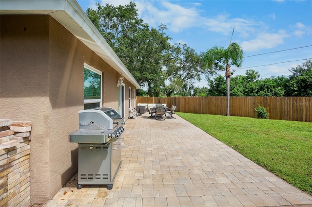 2761 Feiffer Cir, Sarasota, FL 34235 - fenced backyard featuring grilling area, a patio area, and outdoor dining area