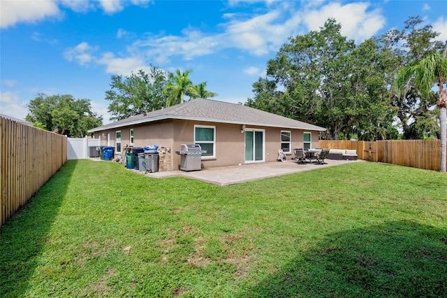 2761 Feiffer Cir, Sarasota, FL 34235 - back of house with stucco siding, a fenced backyard, a patio area, and an outdoor hangout area