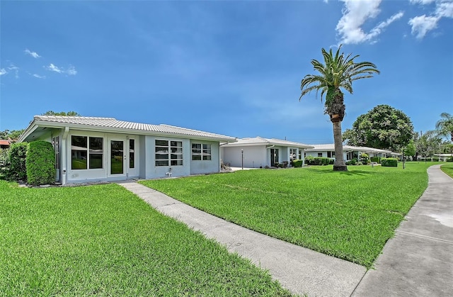 3641 Somerville Dr Unit 1506, Sarasota, FL 34232 - rear view of house featuring a yard and stucco siding