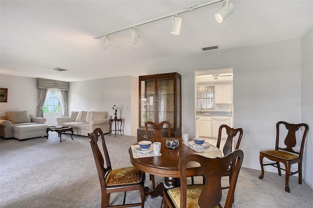 3641 Somerville Dr Unit 1506, Sarasota, FL 34232 - dining room featuring track lighting and light carpet