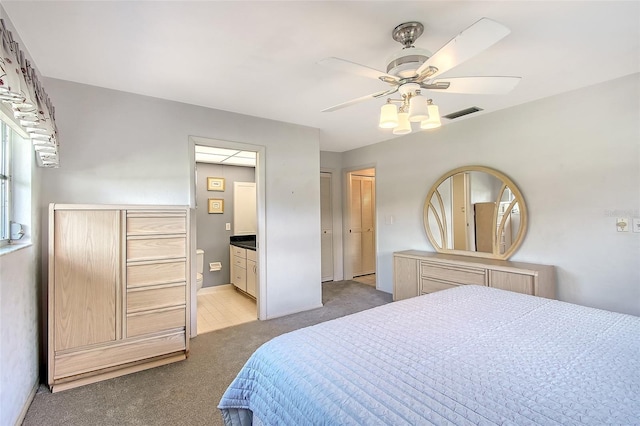 3641 Somerville Dr Unit 1506, Sarasota, FL 34232 - bedroom featuring light carpet, ensuite bathroom, and ceiling fan