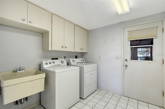3641 Somerville Dr Unit 1506, Sarasota, FL 34232 - laundry area featuring cabinet space, washer and clothes dryer, and light tile patterned floors
